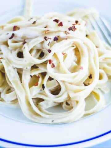 Fettuccine Alfredo toped with pepper flakes