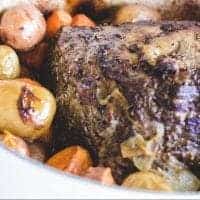 Succulent Rib Roast and potatoes in a dutch oven