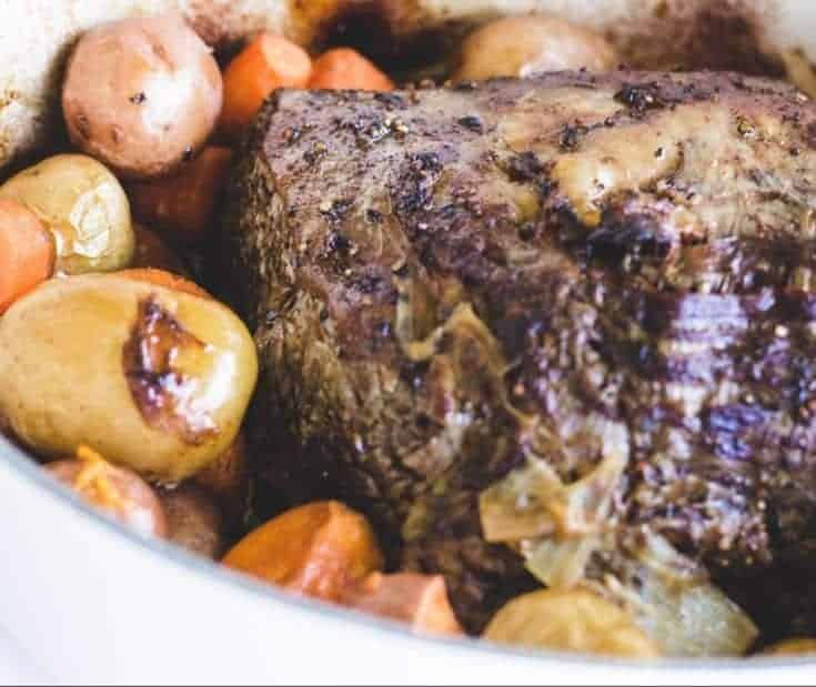 Succulent Rib Roast and potatoes in a dutch oven