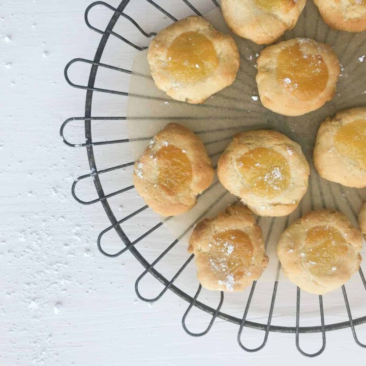 close up of lemon curd cookies on round wire cooling rack.