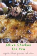 close-up of olive chicken topped with olives, capers and prunes.