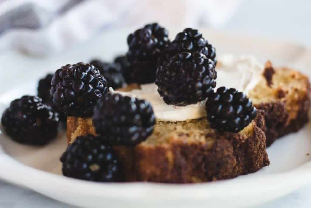 breakfast bread topped with cream cheese and blackberries