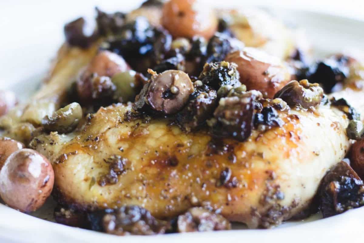 olive chicken and red potatoes on a serving plate.