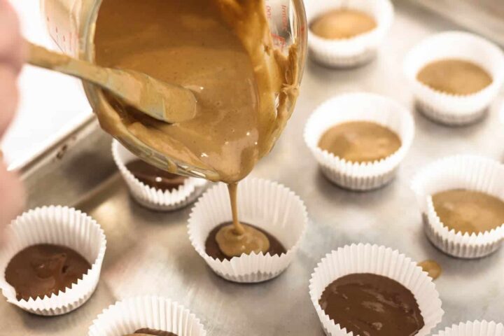 pouring peanut butter into mini cups.