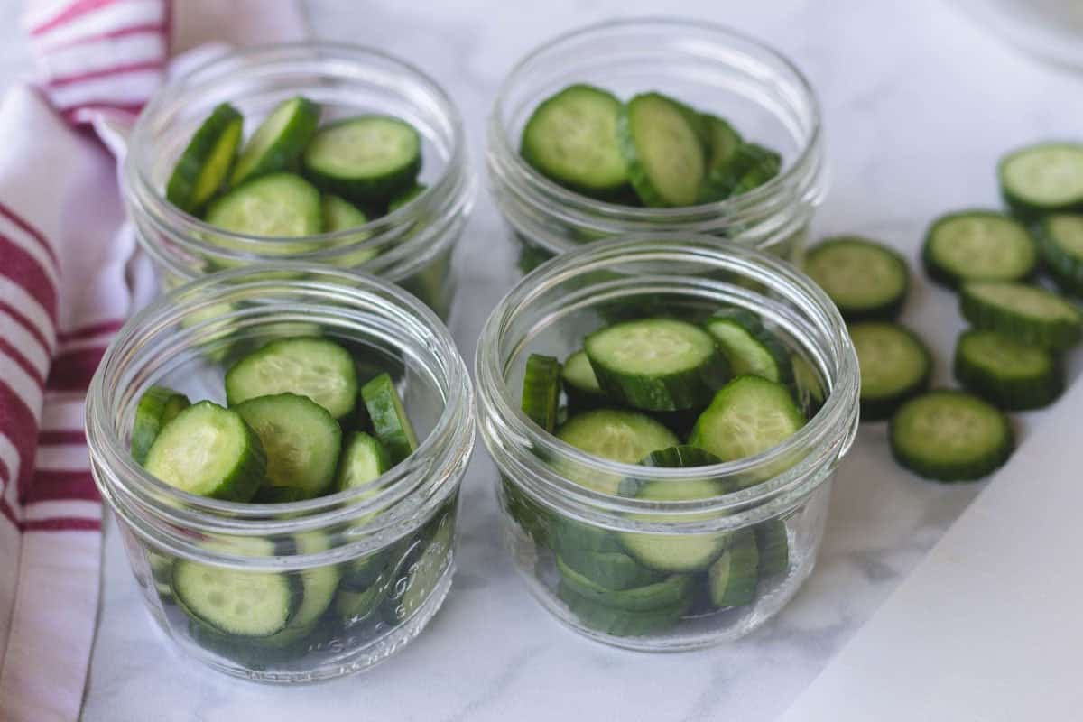 Sliced cucumbers in jars.