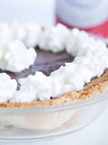 small chocolate pie with whipped cream on top.
