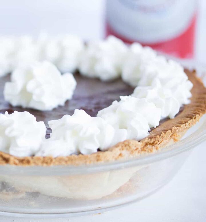 small chocolate pie with whipped cream on top.