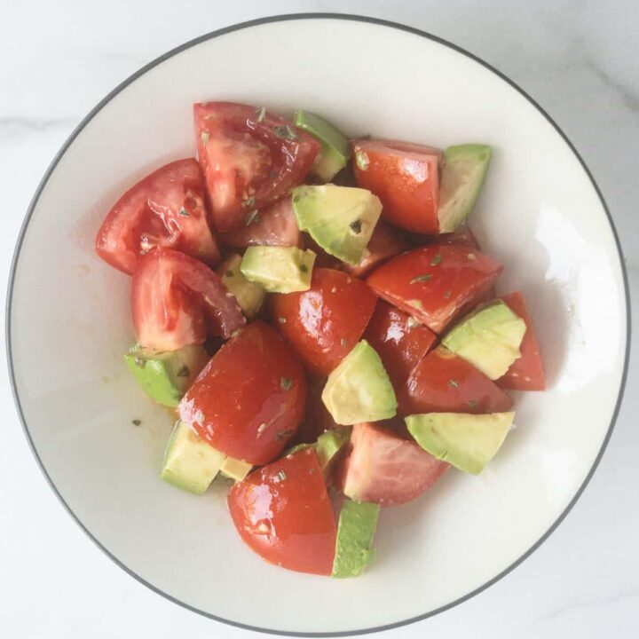 Avocado and tomatoes cut up in bowl.