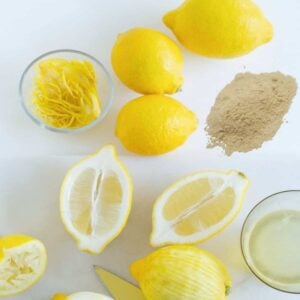 mound of lemon juice powder next to cut lemons