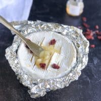 baked camembert cheese topped with cranberries
