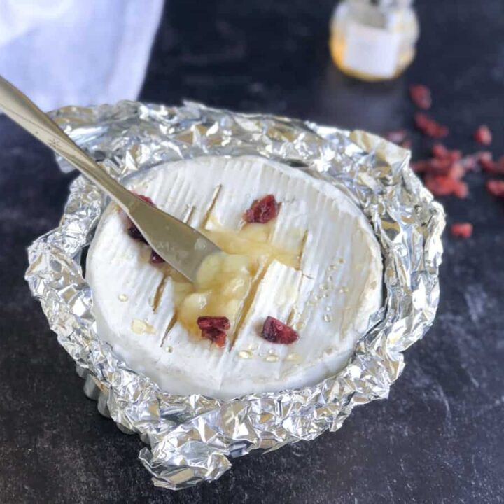 baked camembert cheese topped with cranberries