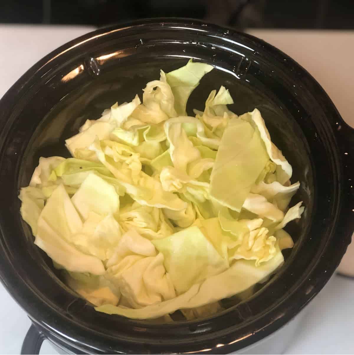 sliced cabbage in crockpot.