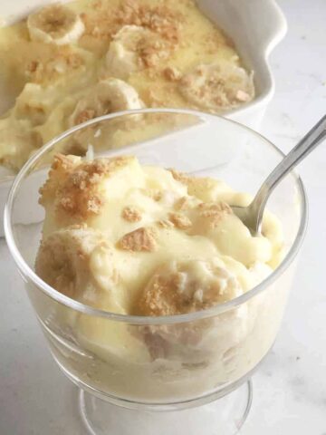 Single serving  of banana pudding in clear dessert cup.