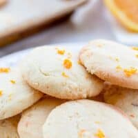 orange sugar cookies on a white plate.