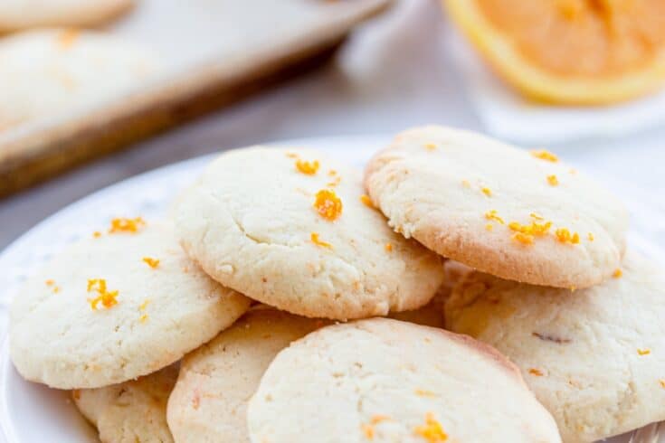 orange sugar cookies on a white plate.