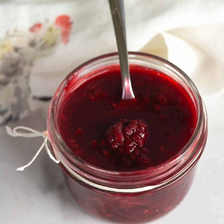 blackberry sauce in clear jelly jar.
