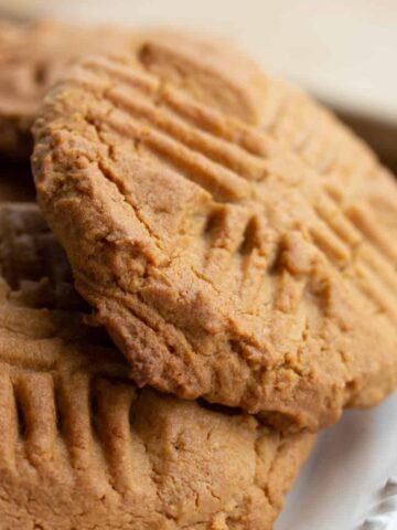 close up of peanut butter cookies on white plate.