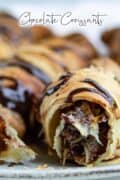 close up of puff pastry chocolate croissants on plate.