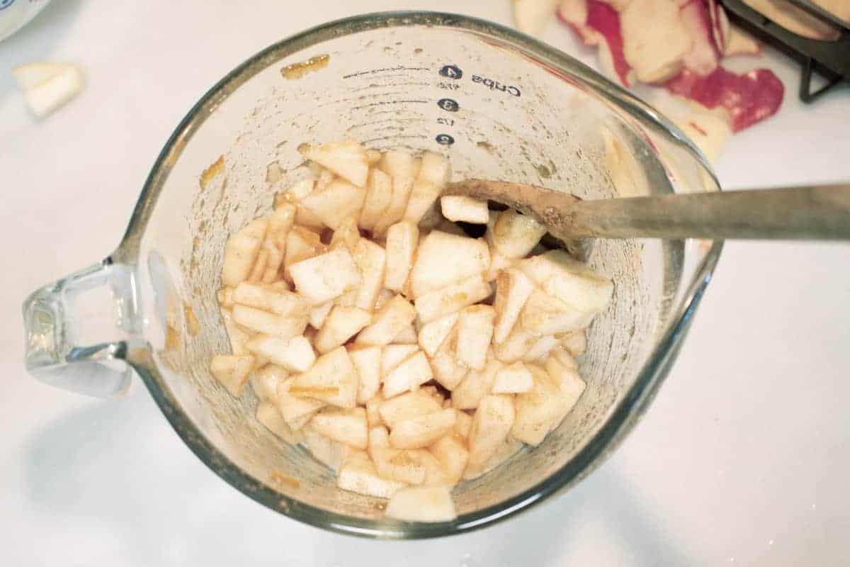 Chopped apples in measuring cup.