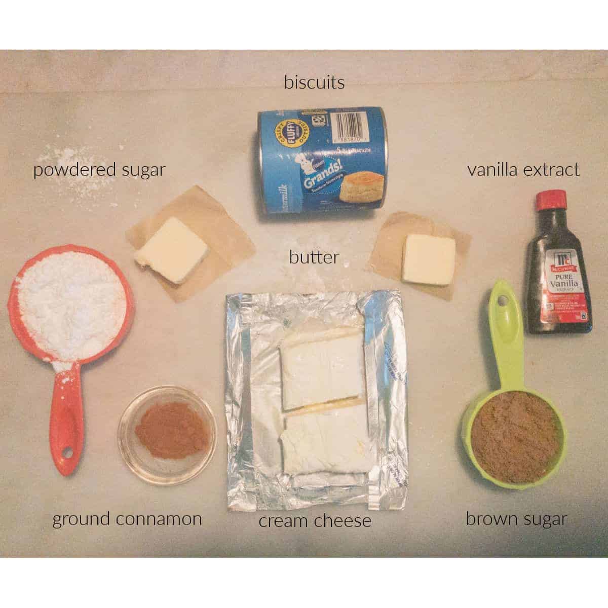 ingredients for cinnamon rolls measuresout onpastry board.