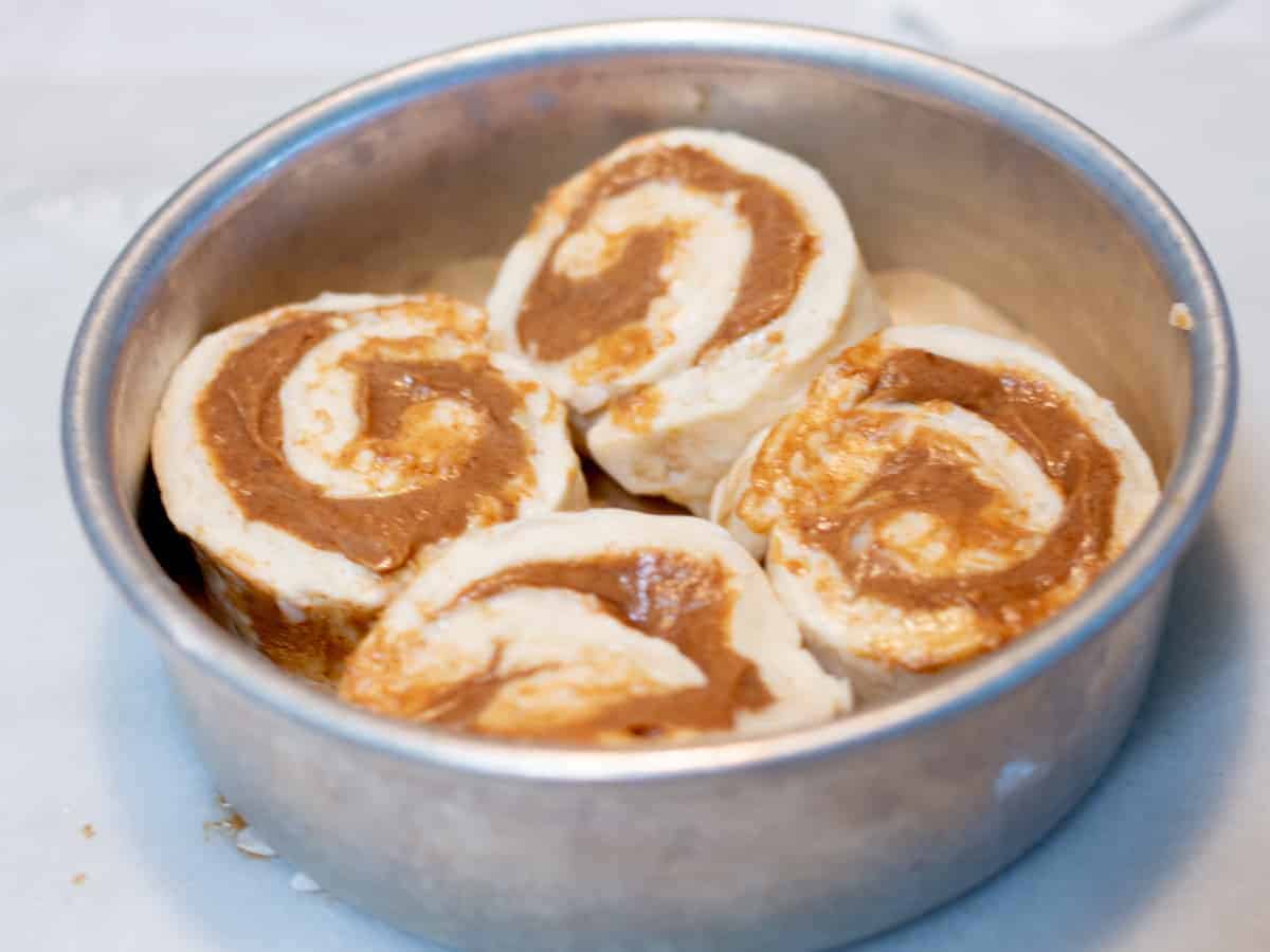 unbaked cinnamon rolls in 6-inch cake pan.