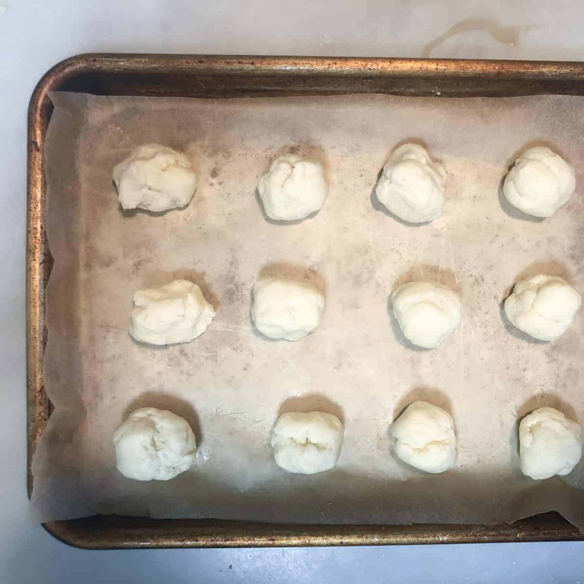 lemon curdcookie dough ballson baking sheet.