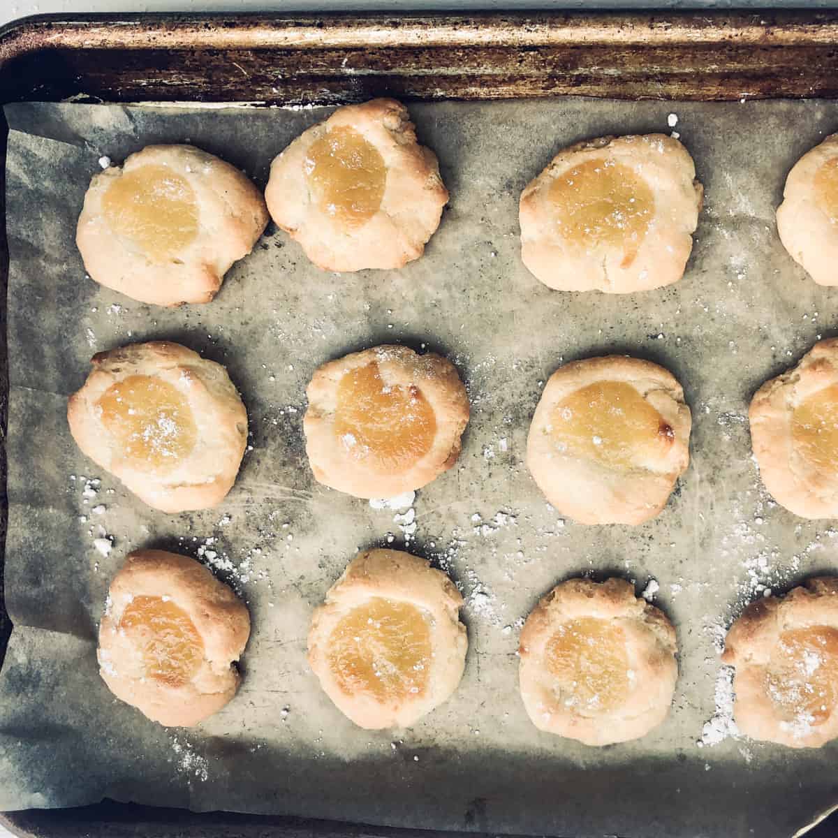 baked lemon curd cookies on baking sheet.