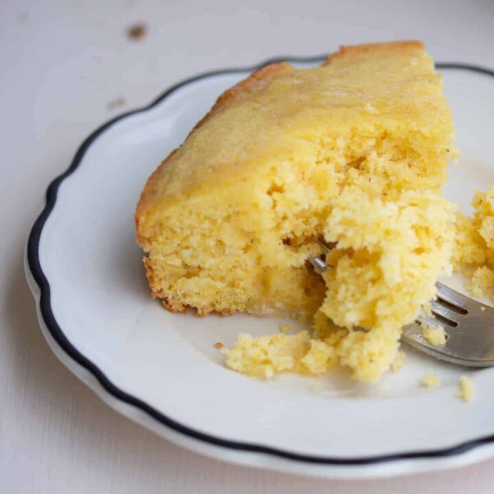 slice of cornbread on white plate.