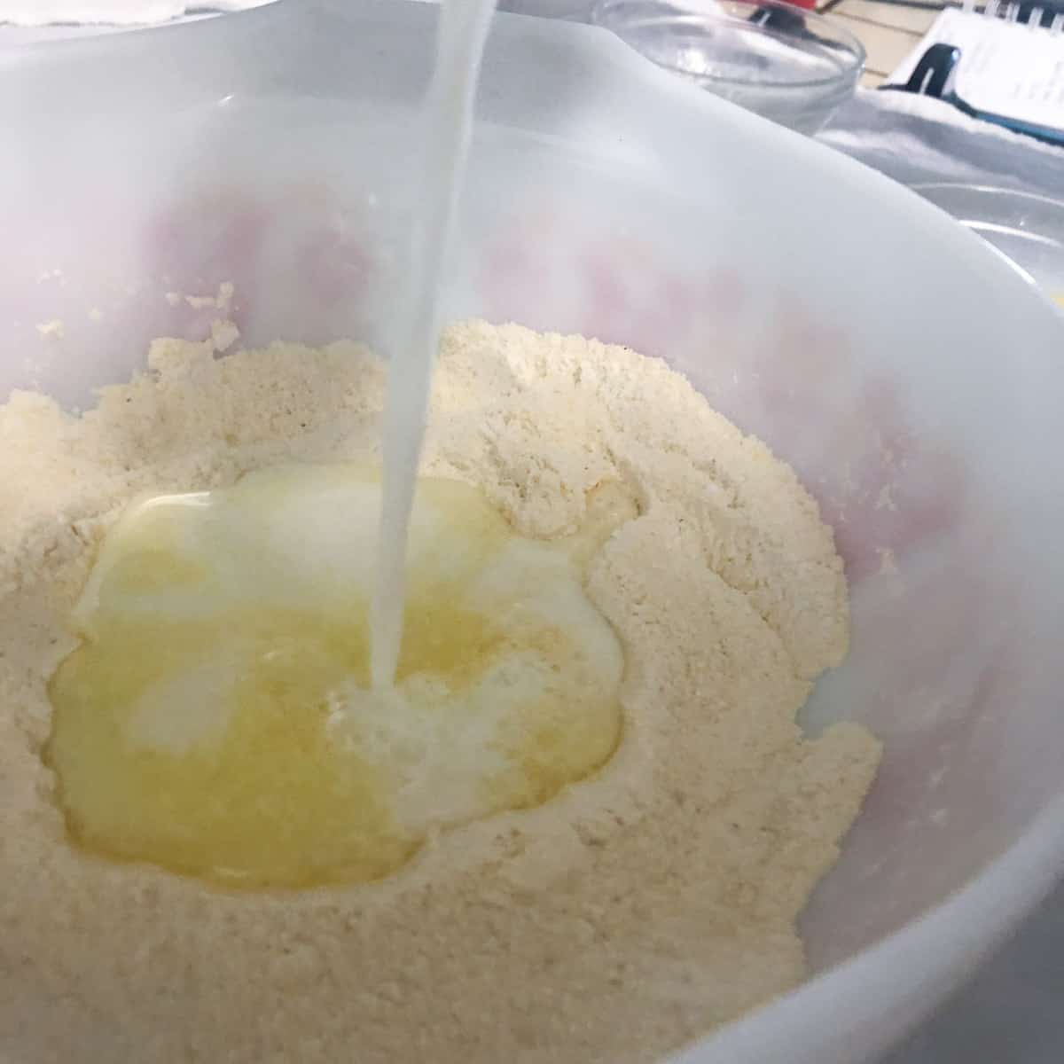 dry and wet ingredients for slow cooker cornbread being mixed together.