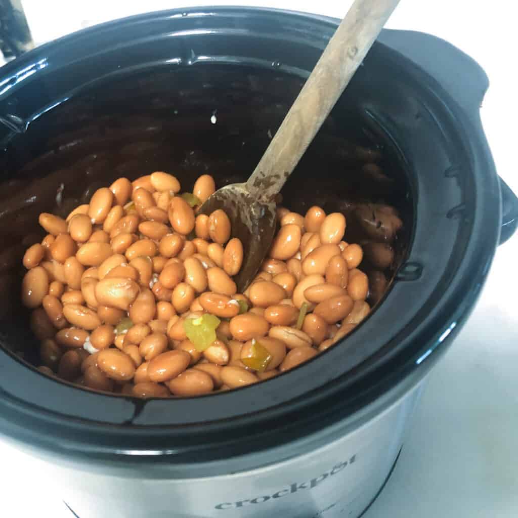 spicy pinto beans stirred and ready to cook.