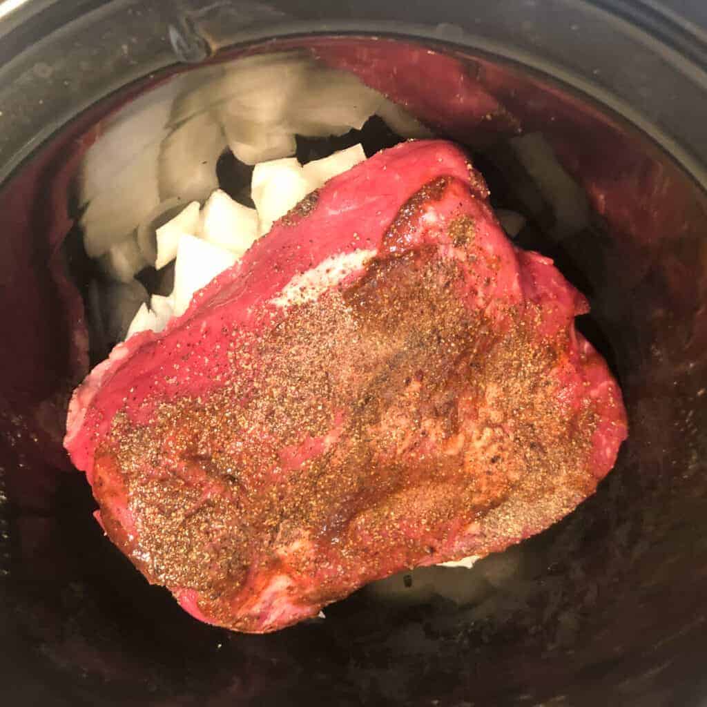 one pound tri tip over onions in slow cooker.