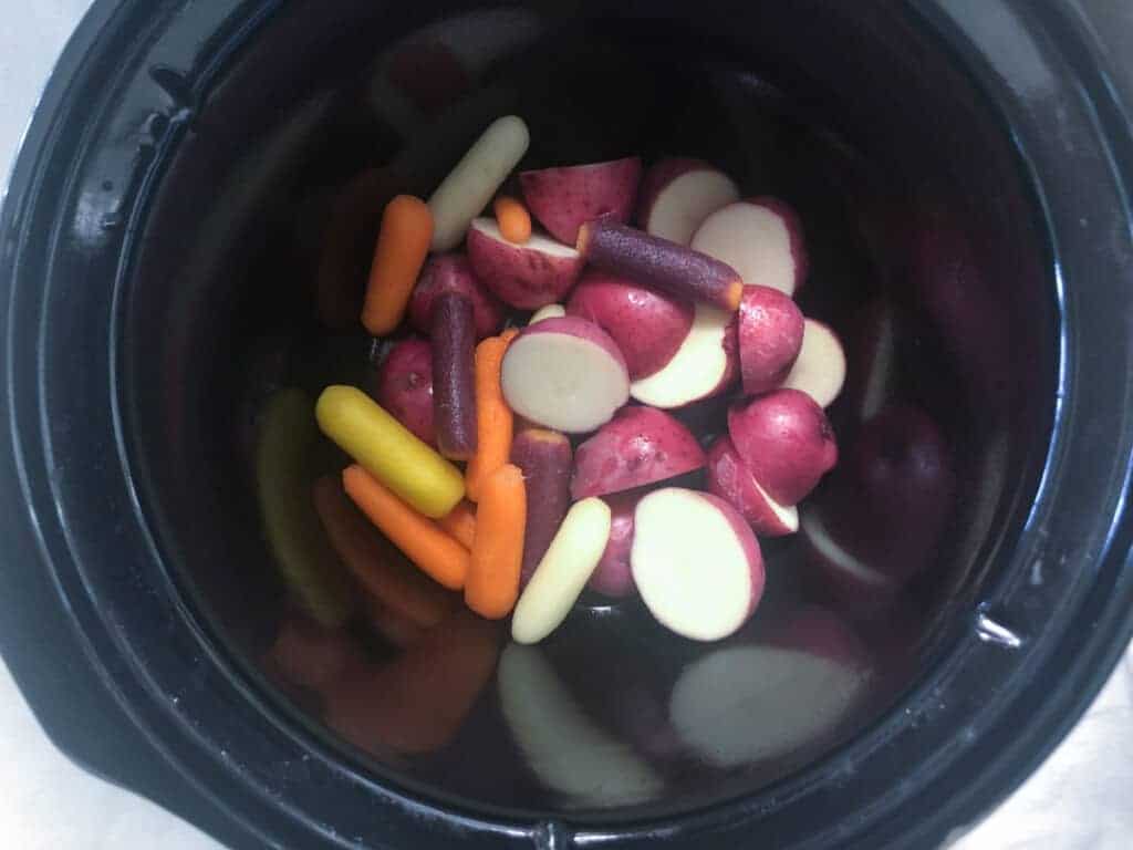 baby carrots, red potatoes in bottomof 3-quart slow cooker.