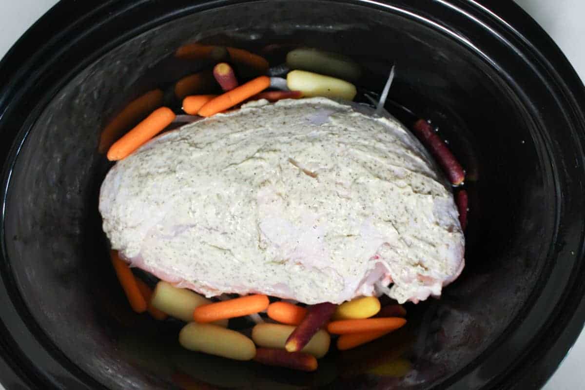 seasoned 2 pound turkey breast and baby carrots in slow cooker.