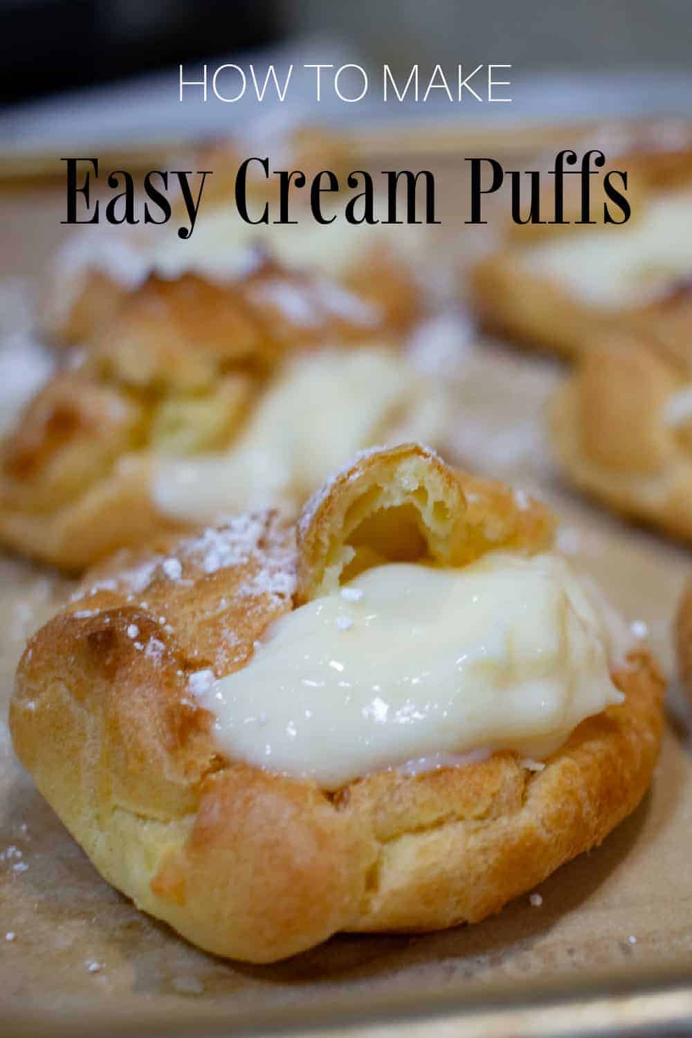 filled cream puffs on parchment lined baking sheet