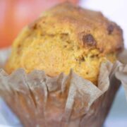 pumpkin muffin in partially peeled open paper liner.