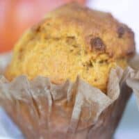 pumpkin muffin in partially peeled open paper liner.