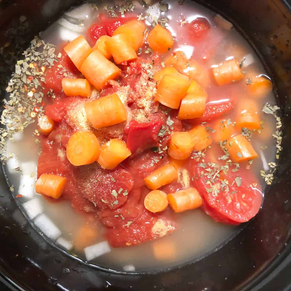 chicken vegetable soup cooking in 3-quart slow cooker.