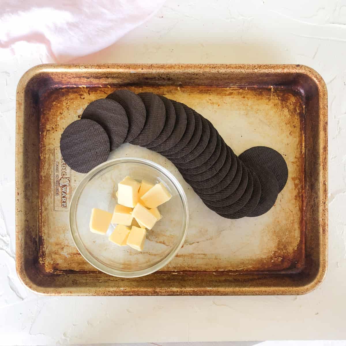 chocolate wafers and cubed butter on baking pan.