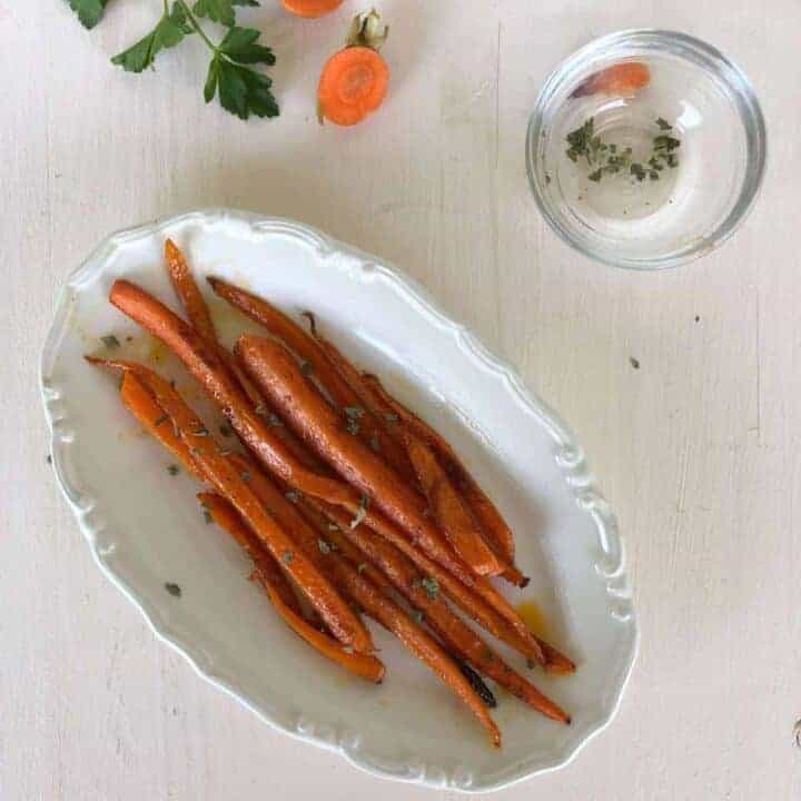 Baked carrots on serving dish.