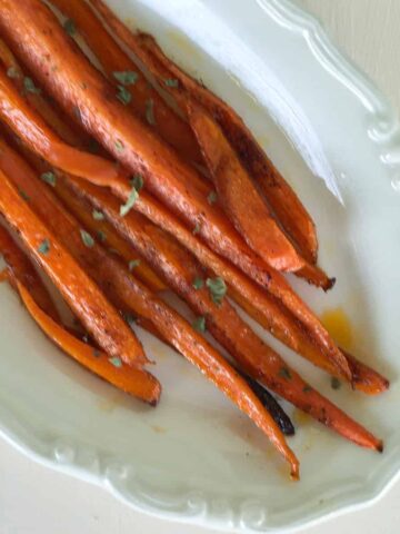 Baked carrots on oval serving dish.
