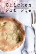 Baked chicken pot pie and fork on table.