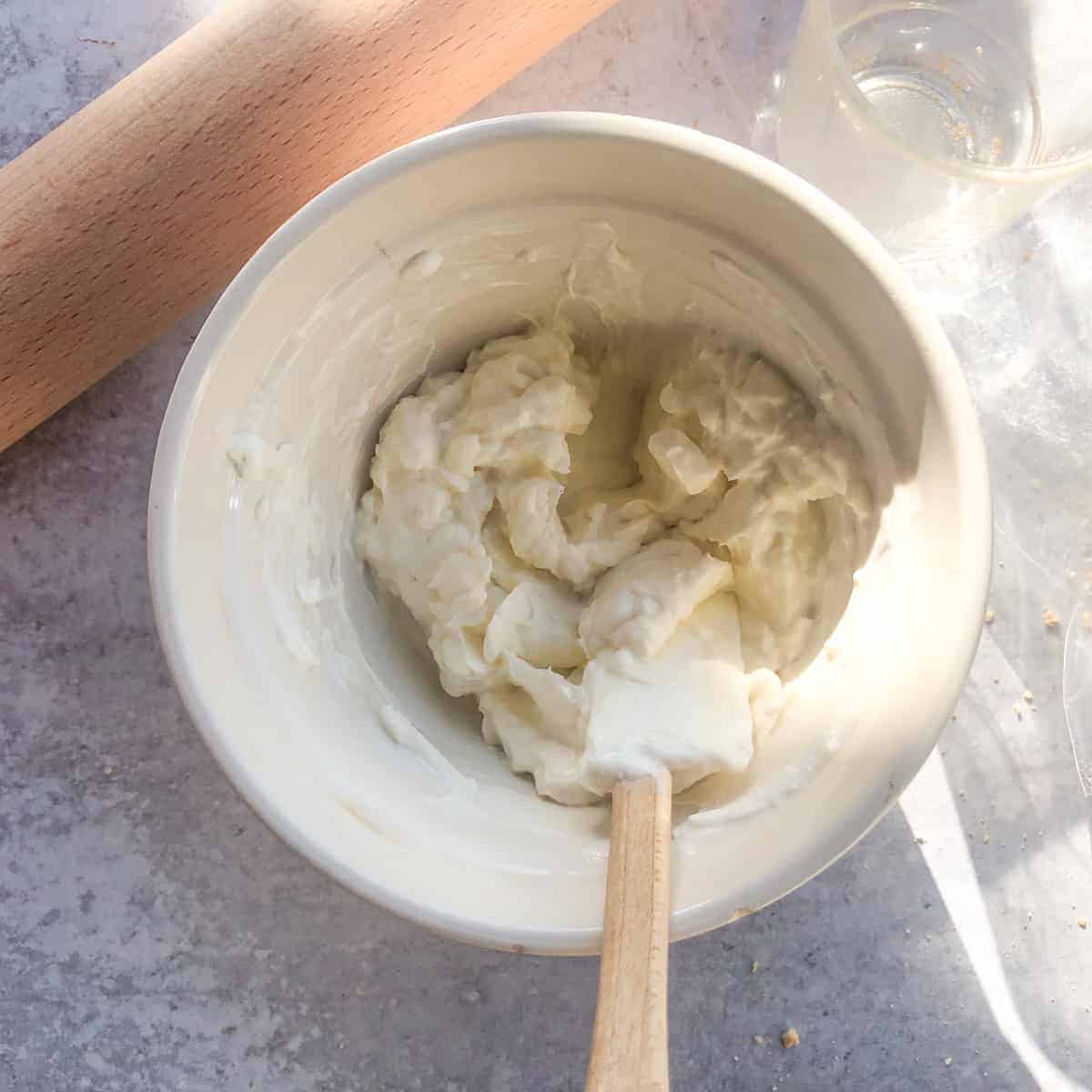 Cream cheese filing in white bowl.
