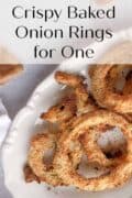 Baked onion rings on serving dish.