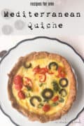 olive quiche on black rimmed plate.