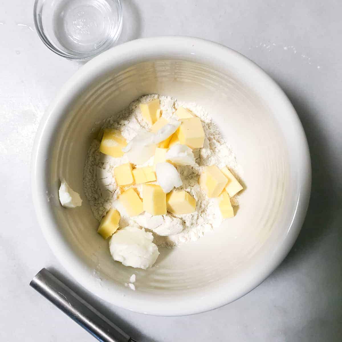 flour and butter in white bowl.
