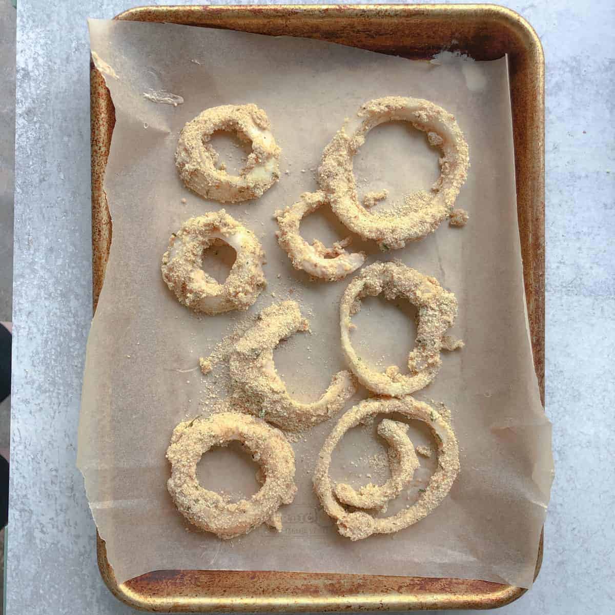 Onion rings on baking sheet.