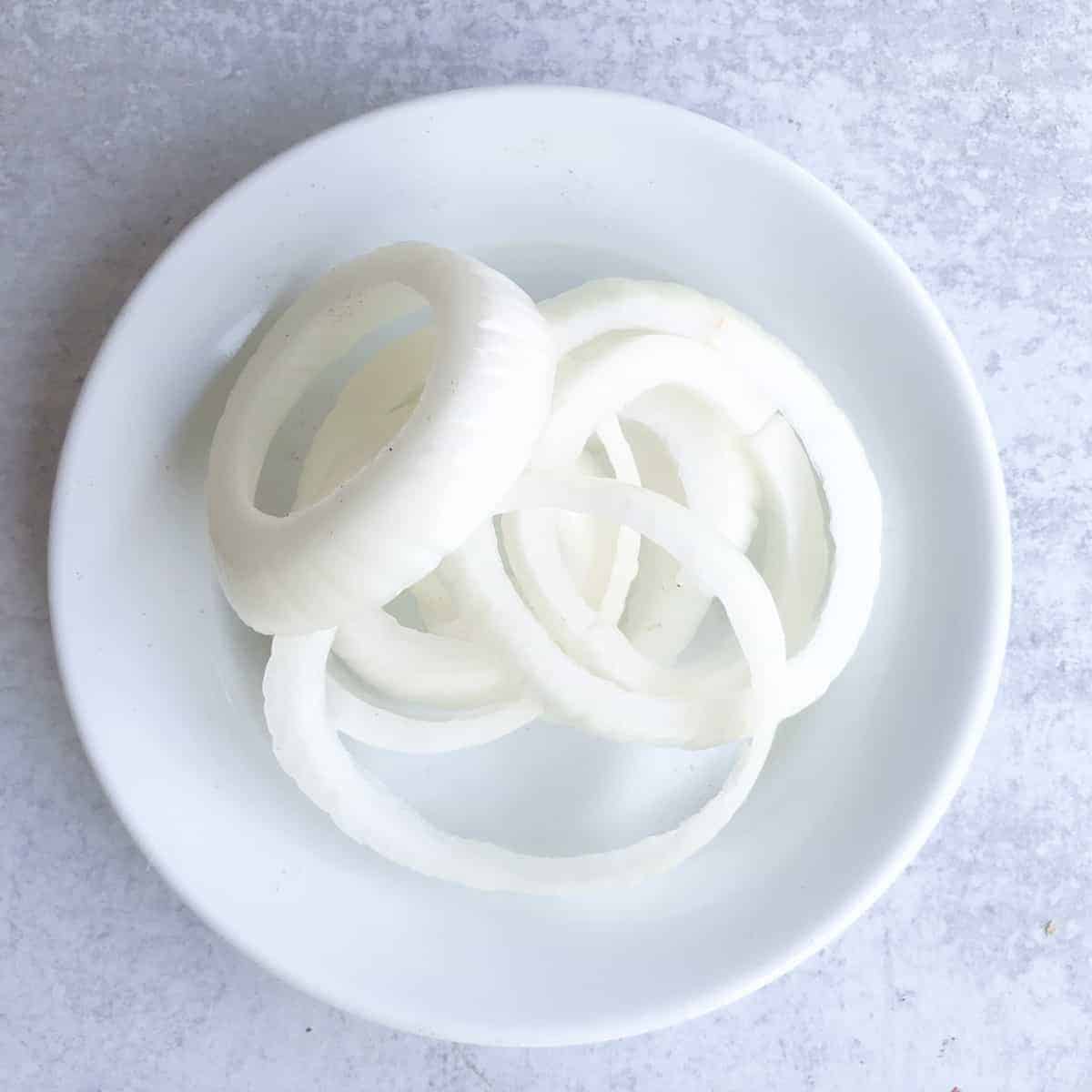 Sliced onions on plate.
