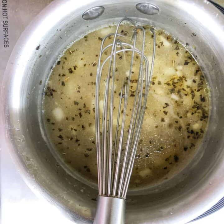 Chicken broth simmering in small saucepan