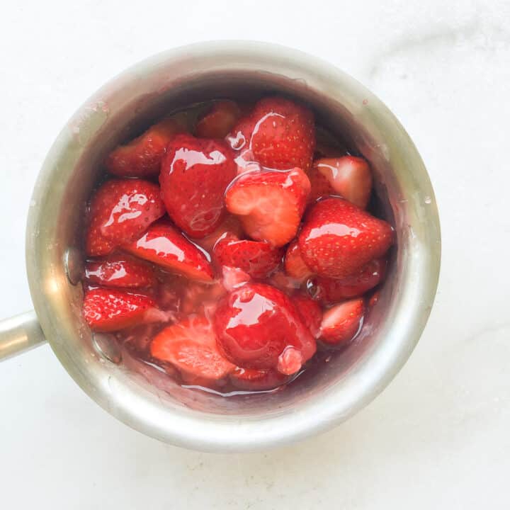 Saucepan of strawberries and glaze.