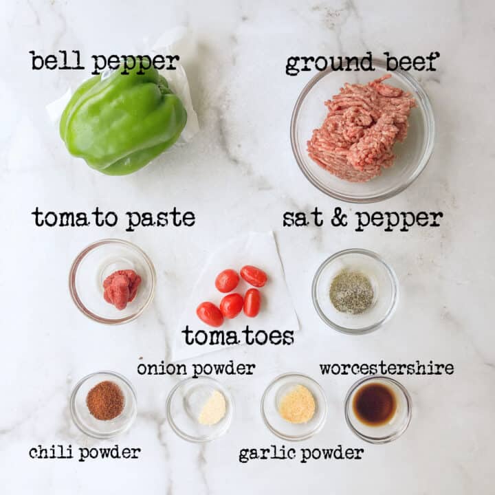Gren bell pepper,ground beef, tomamto paste, grape tomatoes, salt & pepper mix, chili powder, onion powder, garlicpowder and worcestershire sauce in small bowls.
